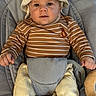 Soan a rejoint le concours — aidez-le/la à gagner de superbes lots ! baby, child, infant, hat, striped_shirt, brown_and_white, pants, beige, baby_seat, sock, monkey_socks, toy, floor, cute, smiling, face, hands, cozy, indoor, portrait