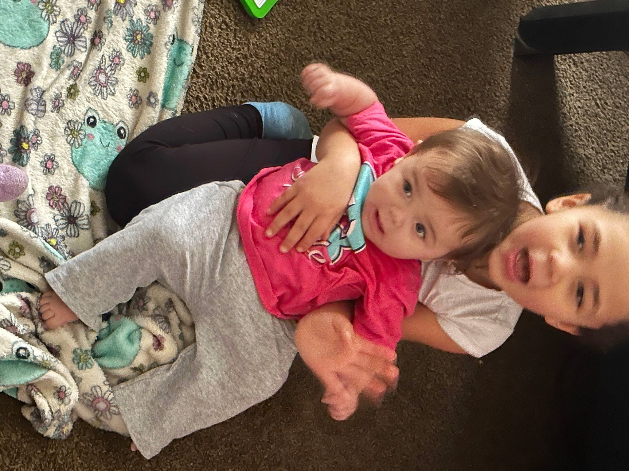 Novaleigh joined the competition — help win amazing prizes! baby_toddler_clothing, child, comfort, finger, flooring, grass, happy, head, human_leg, lap, leg, person, room, sitting, skin, smile, sock, thigh, toddler, tree