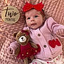 baby, infant, two_months, milestone_card, headband, red_bow, pink_blanket, knit_sweater, cherries_pattern, plush_bear, toy, button, lying_down, portrait, cute, wide_eyes, soft_texture, toddler_clothes, sleepwear, prop