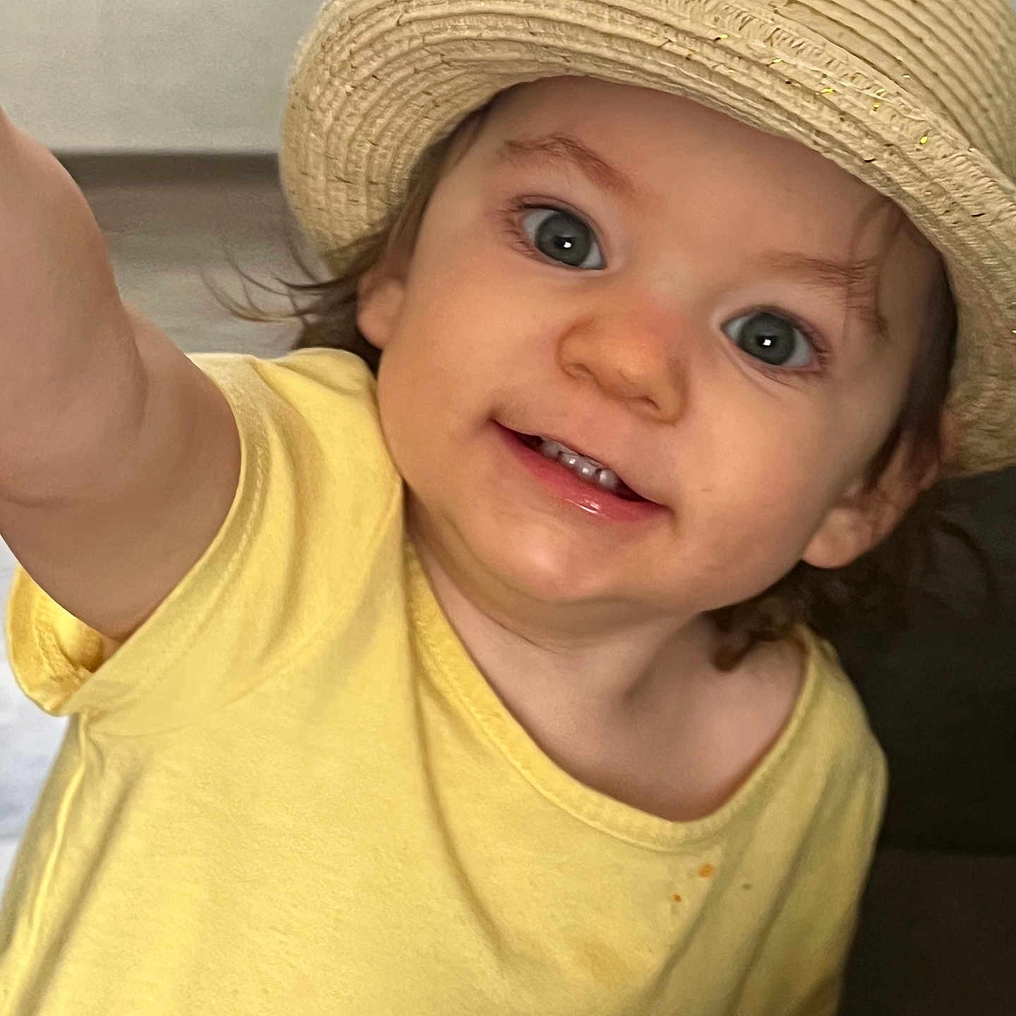 Vyolett is registered to the contest to win money with this photo: baby, child, closeup, clothing, cute, expression, eyes, face, happy, hat, headwear, indoor, person, portrait, skin, smiling, teeth, toddler, yellow_shirt, young