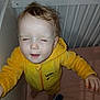 toddler, child, yellow_onesie, crib, bed, indoor, baby, clothing, fuzzy, expression, standing, hand, face, hair, sleepwear, person, furniture, room, pajamas, baby_clothes
