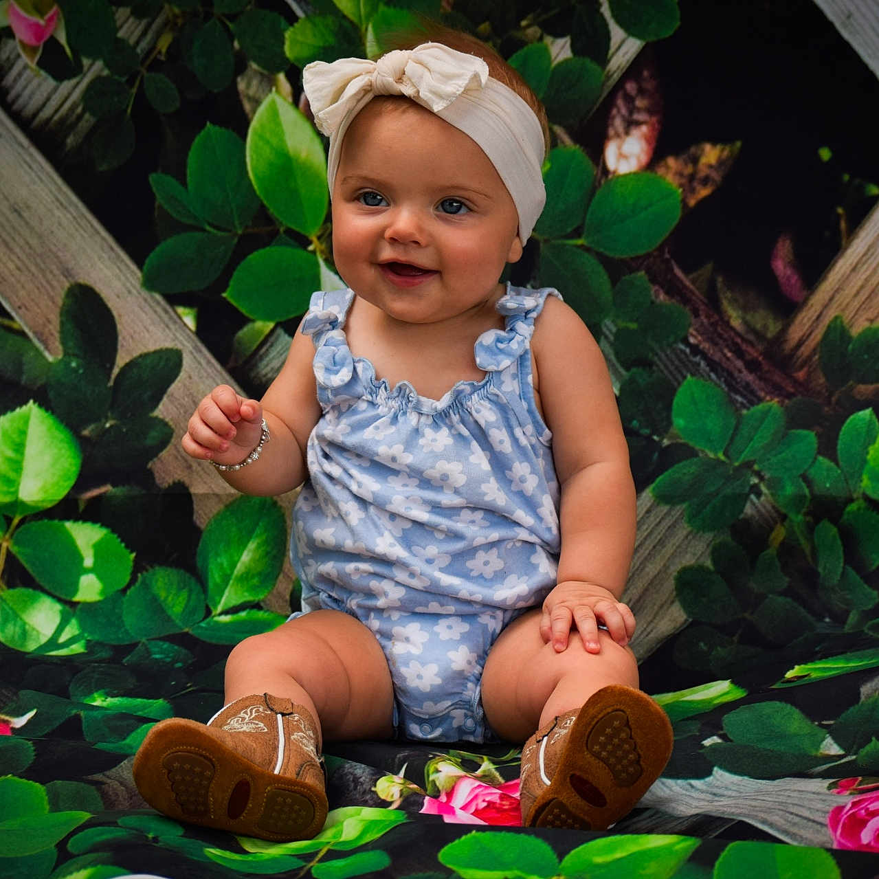 Willow joined the competition — help win amazing prizes! baby, background, boots, bracelet, child, cute, fashion, flower, greenery, happy, headband, infant, leaves, nature, outdoor_style, portrait, romper, sitting, smiling, toddler