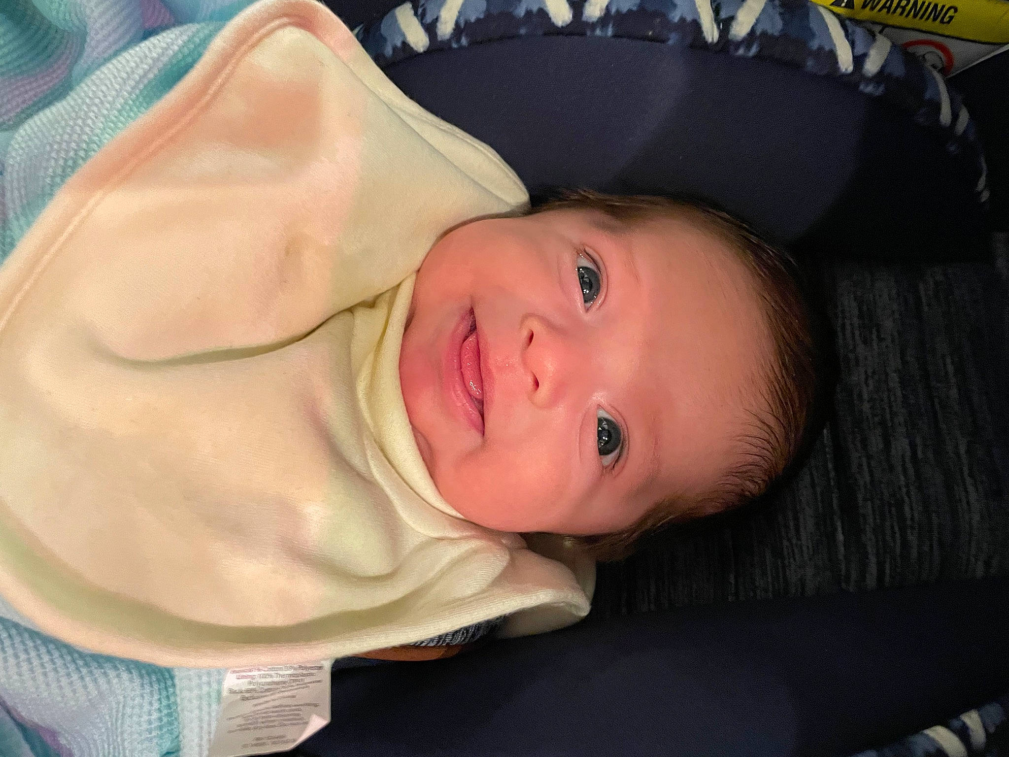 Julian is registered to the contest to win money with this photo: baby, baby_products, baby_toddler_clothing, cheek, chin, comfort, eye, eyebrow, face, fun, head, human_body, iris, lip, mouth, nose, person, skin, sleeve, smile