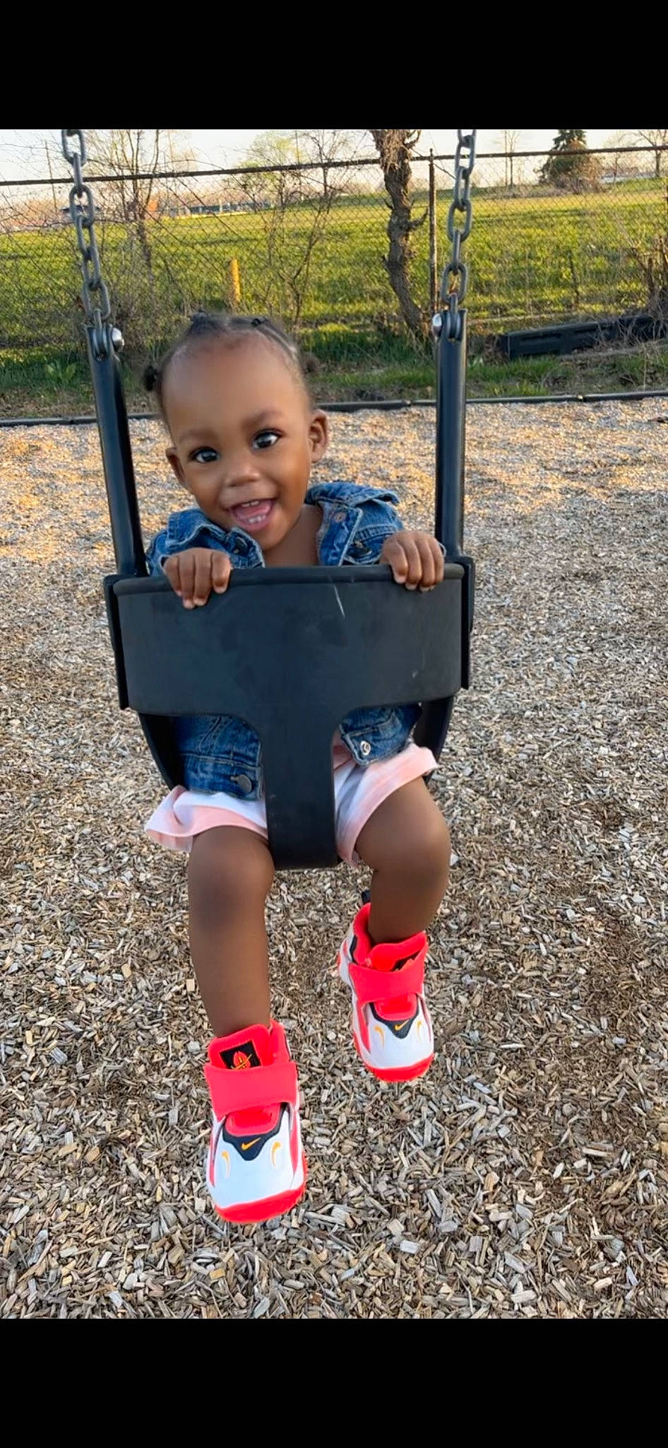 Jshniyla is registered to the contest to win money with this photo: baby, child, city, electric_blue, eye, face, fun, grass, happy, head, human_leg, knee, leisure, people_in_nature, person, playground, smile, sock, swing, thigh