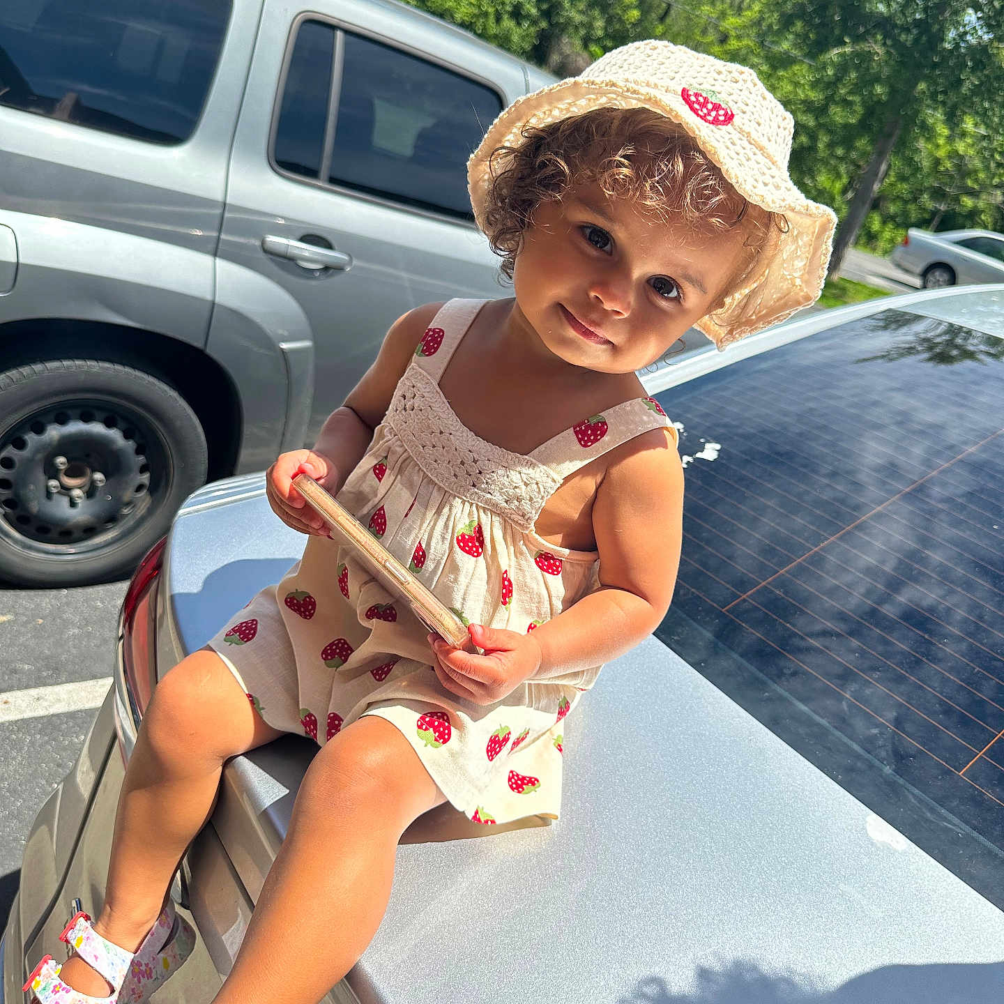 Journi is registered to the contest to win money with this photo: alloywheel, car, carwheel, child, clothing, face, footwear, hat, head, machine, person, photography, portrait, shoe, sitting, spoke, tire, transportation, vehicle, wheel