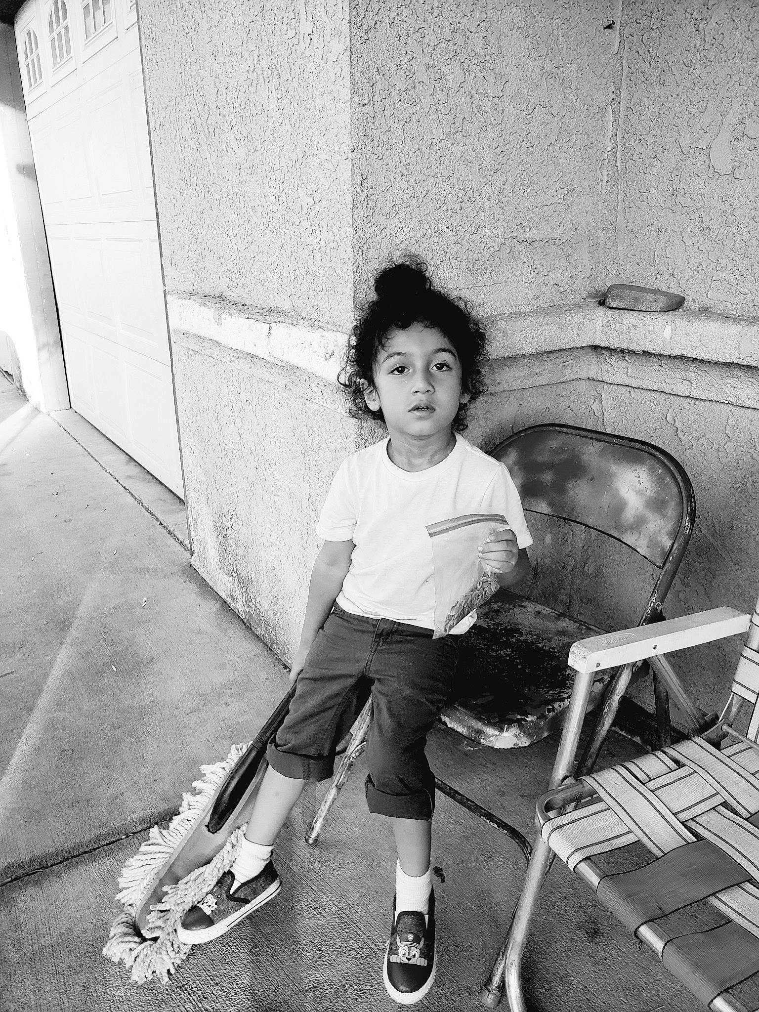 Deshawn is registered to the contest to win money with this photo: black, black_and_white, child, footwear, leg, monochrome, monochrome_photography, person, photograph, photography, shoe, sitting, smile, snapshot, standing, stock_photography, style, white