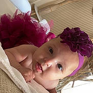 Zaïna a rejoint le concours — aidez-le/la à gagner de superbes lots ! baby, infant, headband, purple, tutu, blanket, face, expression, indoors, child, cute, portrait, toddler, skin, hand, eyes, mouth, clothing, headwear, lying_down