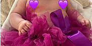 Zaïna a rejoint le concours — aidez-le/la à gagner de superbes lots ! baby, infant, smile, purple, tutu, headband, cushion, blanket, happy, cute, child, sitting, indoors, portrait, soft, fabric, tulle, ribbon, skin, small_hands