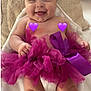 Zaïna a rejoint le concours — aidez-le/la à gagner de superbes lots ! baby, infant, smile, purple, tutu, headband, cushion, blanket, happy, cute, child, sitting, indoors, portrait, soft, fabric, tulle, ribbon, skin, small_hands