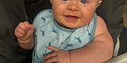 Creed Taylor is registered to the contest to win money with this photo: baby, child, high_chair, bib, blue_eyes, smile, whale_pattern, cute, infant, chubby_cheeks, feeding, happy, clothing, face, hand, indoor, person, portrait, skin, seat