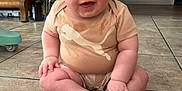 Creed Taylor joined the competition — help win amazing prizes! baby, child, sitting, floor, tile, indoor, smiling, happy, onesie, clothing, puma_logo, hands, feet, wooden_furniture, baby_walker, head, face, legs, crawling, stains