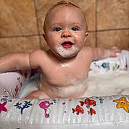 Creed Taylor is registered to the contest to win money with this photo: baby, bath, bathtub, bubbles, child, cute, face, foam, happy, indoor, inflatable, person, playful, sitting, skin, smiling, soap, tile, tub, water