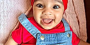 Nyra joined the competition — help win amazing prizes! baby, cherry_pattern, child, closeup, clothing, cute, denim_overalls, face, happy, headwear, hello_kitty, human, indoor, infant, joyful, pink_blanket, portrait, red_headband, smiling, toddler