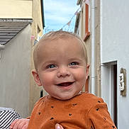 Alex joined the competition — help win amazing prizes! baby, child, smiling, happy, person, outdoor, sky, building, hand, clothing, holding, face, head, blue_eyes, casual_wear, infant, street, daylight, cute, portrait