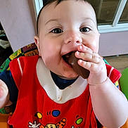 Klay is registered to the contest to win money with this photo: baby, child, chocolate, clown_image, cute, eyes, face, fingers, food, hand, happy, highchair, indoor, joy, messy, mouth, person, red_bib, skin, smiling