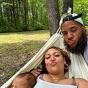 Bolivar joined the competition — help win amazing prizes! baby, beard, cap, couple, forest, grass, hammock, headwear, leaves, nature, outdoor, parent, person, portrait, relaxing, sleeping_baby, tree, woman, young_adult, smiling