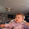 River joined the competition — help win amazing prizes! baby, child, high_chair, pink_clothing, snowflake_pattern, indoor, living_room, ceiling_fan, television, smiling, happy, cute, infant, person, furniture, curious, seated, head, face, hand