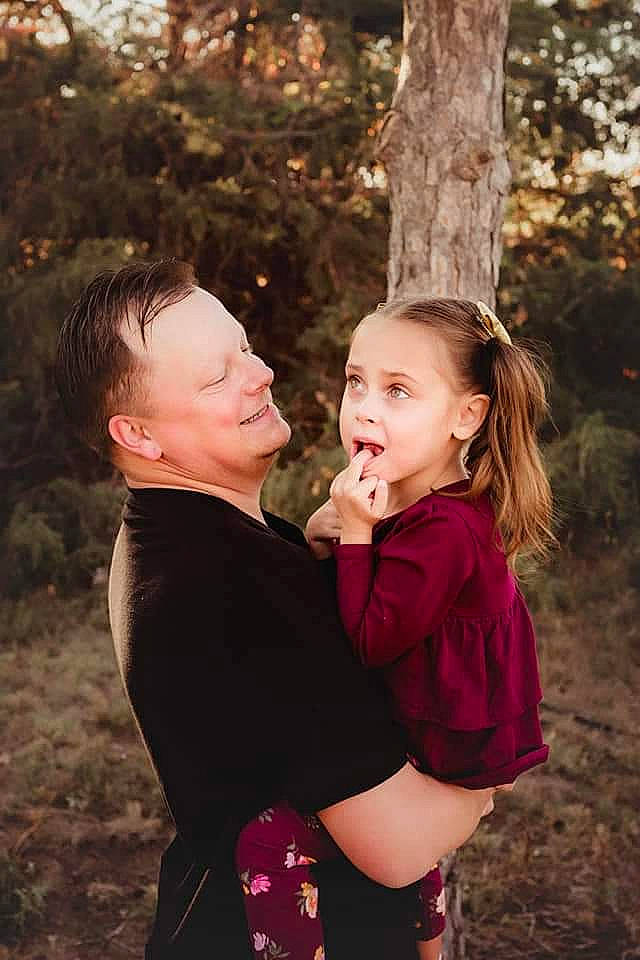 Brellie is registered to the contest to win money with this photo: child, event, flash_photography, forest, fun, gesture, grass, happy, hug, interaction, joy, laugh, leisure, people_in_nature, person, plant, sitting, smile, toddler, tree