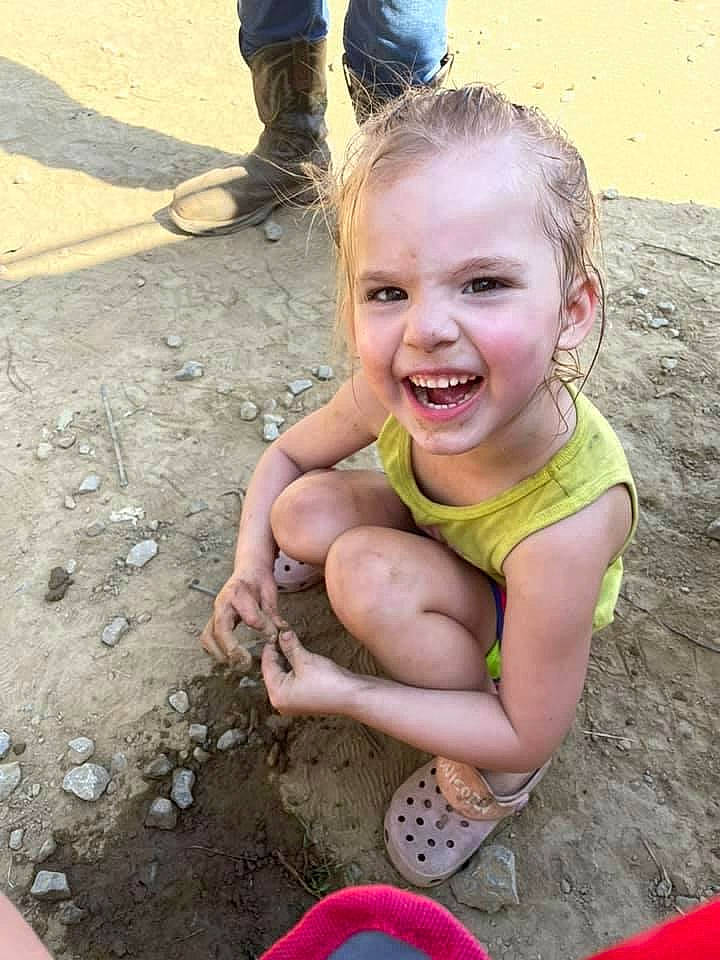 Adalynne is registered to the contest to win money with this photo: blue, body_of_water, child, foot, fun, happy, joy, leg, leisure, mouth, people, people_in_nature, person, photograph, recreation, sand, sitting, smile, soil, summer