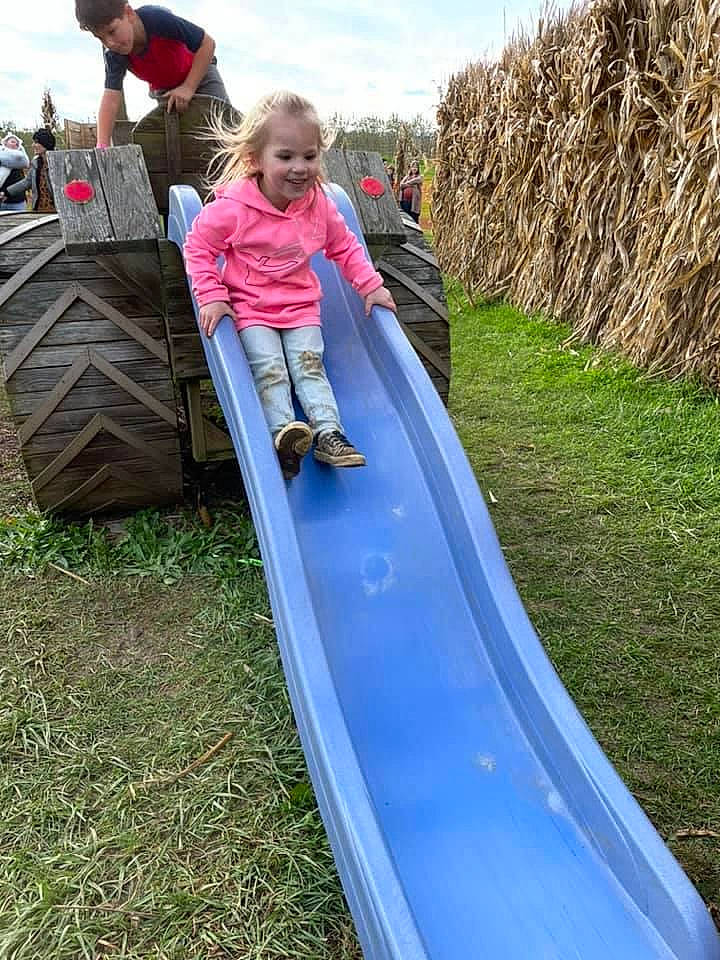 Adalynne is registered to the contest to win money with this photo: child, chute, city, cloud, fun, grass, joy, leisure, outdoor_play_equipment, person, plant, play, playground, playground_slide, pole, recreation, sky, soil, toddler, tree