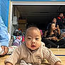 Erzabelle is registered to the contest to win money with this photo: baby, child, indoor, floor, sweater, drool, tissue, people, sitting, backpack, wooden_floor, blue_wall, casual, group, young_child, curious, portrait, candid, gymnasium, community_space