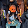 baby, car_seat, infant, child, pacifier, clothing, seatbelt, sunlight, shadow, green_socks, white_shirt, blue_pants, safety, portrait, young_child, cute, indoors, fabric, straps, comfort