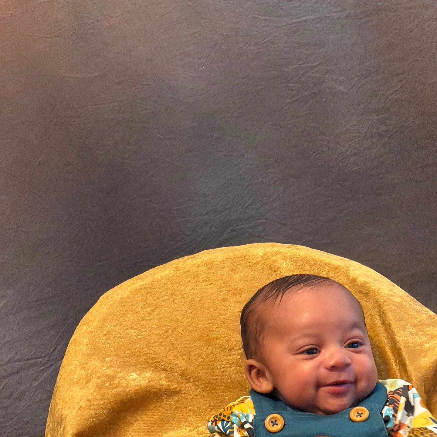 Sekai joined the competition — help win amazing prizes! baby, child, smiling, infant, cute, portrait, yellow_blanket, colorful_clothing, lion_patch, happy, seated, indoors, soft_texture, fabric, head, face, person, clothing, young, skin