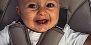 Roman participe au concours pour gagner de l'argent avec cette photo : accessories, baby, babylaughing, bodypart, clothing, coat, cushion, face, happy, head, homedecor, jacket, laughing, mouth, person, photography, portrait, smile, teeth, vest