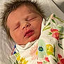 baby, newborn, sleeping, blanket, floral_pattern, infant, peaceful, wrapped, spiky_hair, face, closed_eyes, soft, cute, portrait, child, bed, resting, skin, mouth, nose