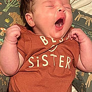Lily joined the competition — help win amazing prizes! baby, infant, yawning, onesie, clothing, patterned_cushion, animal_print, sleepy, cute, child, newborn, soft_skin, hand, face, mouth_open, lying_down, toddler, indoor, portrait, expression