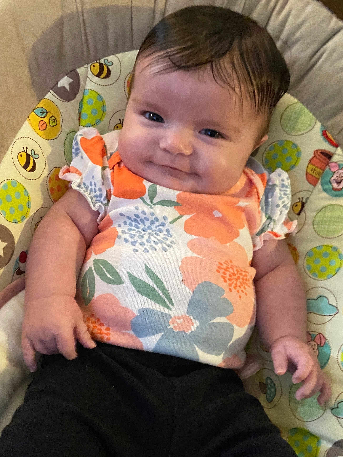Lily joined the competition — help win amazing prizes! baby, child, infant, smile, face, floral_shirt, black_pants, baby_chair, colorful, pattern, bee, polka_dot, cute, happy, sitting, portrait, clothing, skin, person, indoors