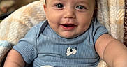 Silas joined the competition — help win amazing prizes! baby, blanket, blue_shirt, child, clothing, cozy, cute, eyes, face, hand, happy, human, indoors, infant, person, portrait, skin, smiling, soft_texture, toddler