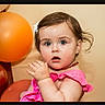 Ava joined the competition — help win amazing prizes! toddler, child, baby, pink_dress, balloon, orange_balloon, portrait, curious, indoor, person, cute, face, young_child, hair_clip, expression, chubby_cheeks, necklace, skin, blue_eyes, innocence