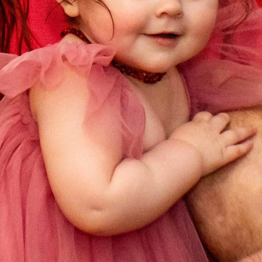 Ava is registered to the contest to win money with this photo: toddler, child, dress, pink, green_bow, hair, face, eyes, arm, hand, person, cute, smile, skin, portrait, indoor, fabric, clothing, baby, young