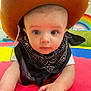 Archie is registered to the contest to win money with this photo: baby, child, cowboy_hat, bandana, play_mat, rainbow, indoor, colorful, portrait, cute, infant, face, hand, expression, costume, hat, curious, skin, person, young