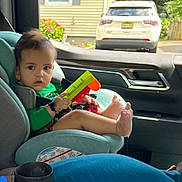 Ayasha joined the competition — help win amazing prizes! child, toddler, car_seat, toy, barefoot, car_interior, window, seatbelt, person, green_clothing, foot, hand, vehicle, parking, outside, daylight, face, hair, seat, plastic_toy