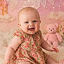 baby, smiling, child, floral_dress, pink_teddy_bear, soft_rug, pastel_background, clouds, twinkling_lights, cute, happy, portrait, indoors, sitting, infant, cheerful, plush_toy, decor, face, blue_eyes