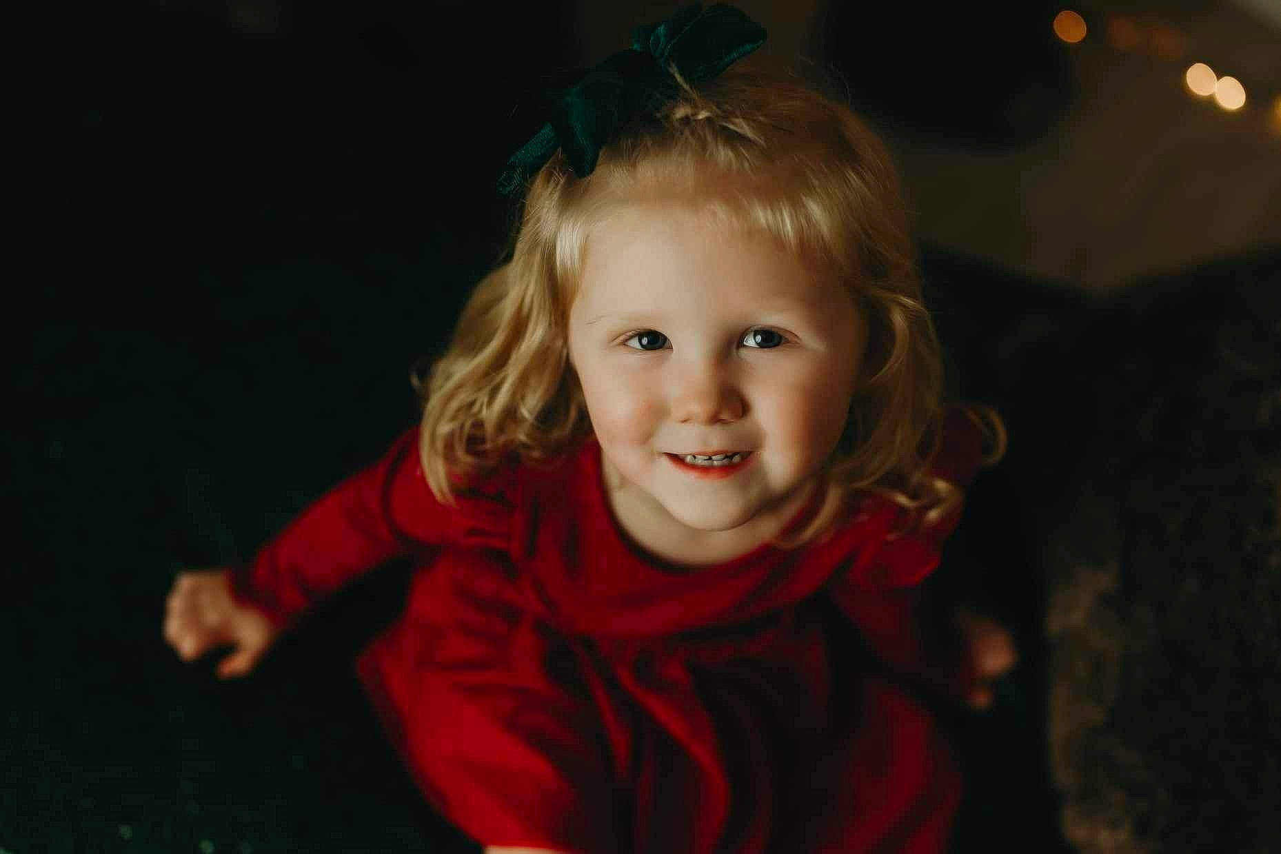 Haven is registered to the contest to win money with this photo: blond, cheek, child, darkness, event, eye, flash_photography, fun, grass, happy, iris, joy, laugh, night, nose, person, portrait_photography, sitting, smile, toddler