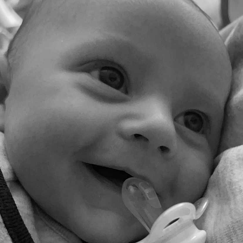 Frankie is registered to the contest to win money with this photo: baby, black, cheek, chin, ear, eye, eyebrow, facial_expression, hand, happy, head, human, iris, lip, mouth, nose, organ, skin, smile, white