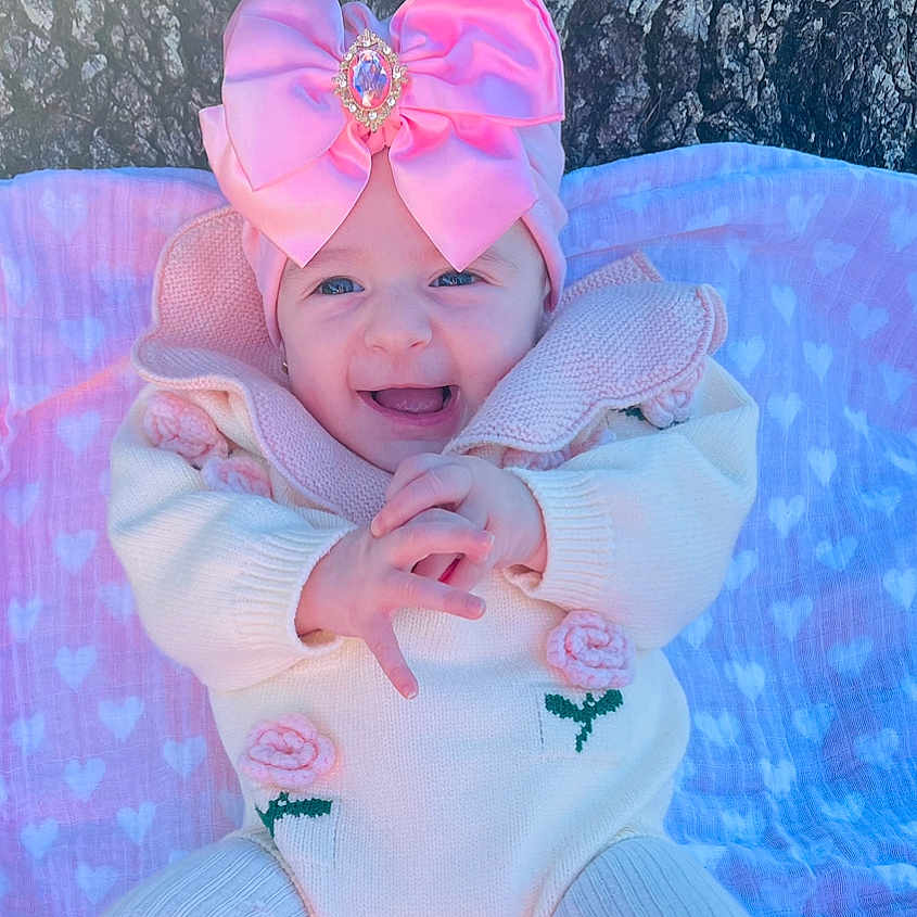 Leyla joined the competition — help win amazing prizes! accessories, baby, bed, cap, clothing, costume, dress, face, formalwear, furniture, happy, hat, head, laughing, newborn, person, photography, portrait, purple, tie