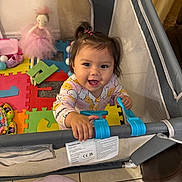 Hailey joined the competition — help win amazing prizes! baby, child, toddler, smiling, happy, portrait, playpen, indoor, toys, doll, puzzle_mat, colorful,  ಆಟ?