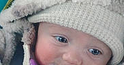 Amelia is registered to the contest to win money with this photo: baby, blanket, blue_eyes, child, closeup, cold_weather_clothing, cozy, cute, face, hooded_jacket, indoors, infant, knitted_hat, pacifier, portrait, small_person, snug, soft_texture, warm, winter