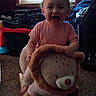baby, bedroom, blinds, carpet, child, happy, indoors, laughing, laundry, lion, pink_shirt, portrait, rocking_toy, sitting, smiling, storage_bins, stuffed_animal, toddler, toy, window