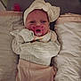 baby, infant, pacifier, headwear, bow, blanket, clothing, sleeping_bag, soft_toys, newborn, cute, child, indoors, bed, padded_surface, swaddled, portrait, wrapped, resting, cozy