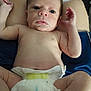 arms, baby, child, closeup, cute, diaper, expression, face, human, indoors, infant, lap, legs, lying, newborn, person, raising_arms, skin, small, soft_light