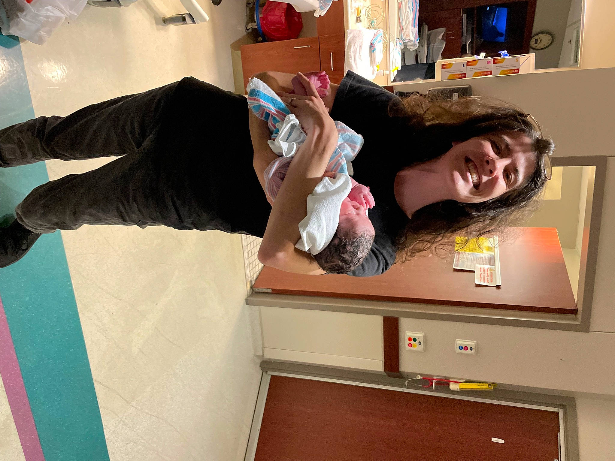 Charlie is registered to the contest to win money with this photo: arm, bookcase, child, comfort, finger, flooring, fun, gesture, home_appliance, house, human_leg, joy, leg, person, room, shelf, shelving, smile, snapshot, t_shirt