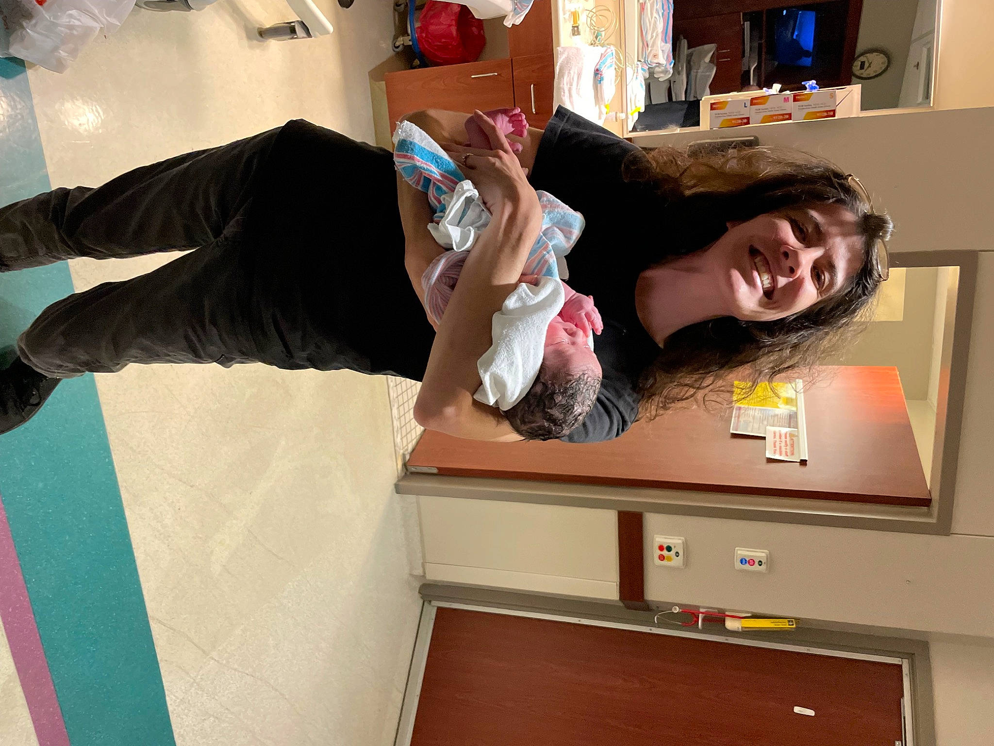 Charlie is registered to the contest to win money with this photo: arm, bookcase, comfort, eyewear, finger, flooring, fun, gesture, hardwood, house, human_leg, joy, leg, person, room, shelf, shelving, shoulder, smile, snapshot