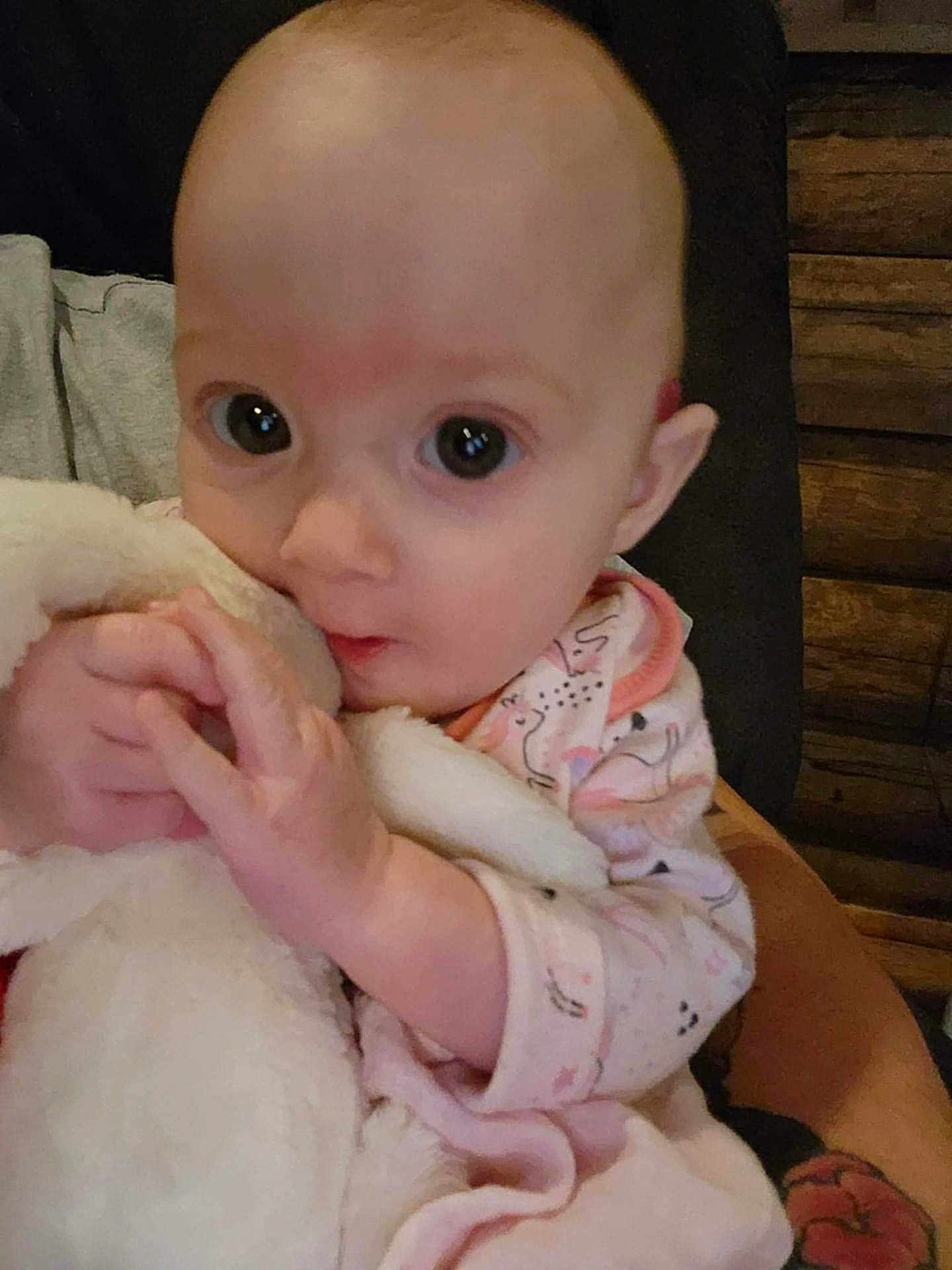 Delilah joined the competition — help win amazing prizes! baby, infant, blanket, clothing, cute, face, hand, holding, indoors, person, portrait, soft, warm, young, child, expression, skin, sleeve, comfort, toddler