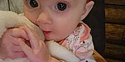 Delilah is registered to the contest to win money with this photo: baby, infant, blanket, clothing, cute, face, hand, holding, indoors, person, portrait, soft, warm, young, child, expression, skin, sleeve, comfort, toddler