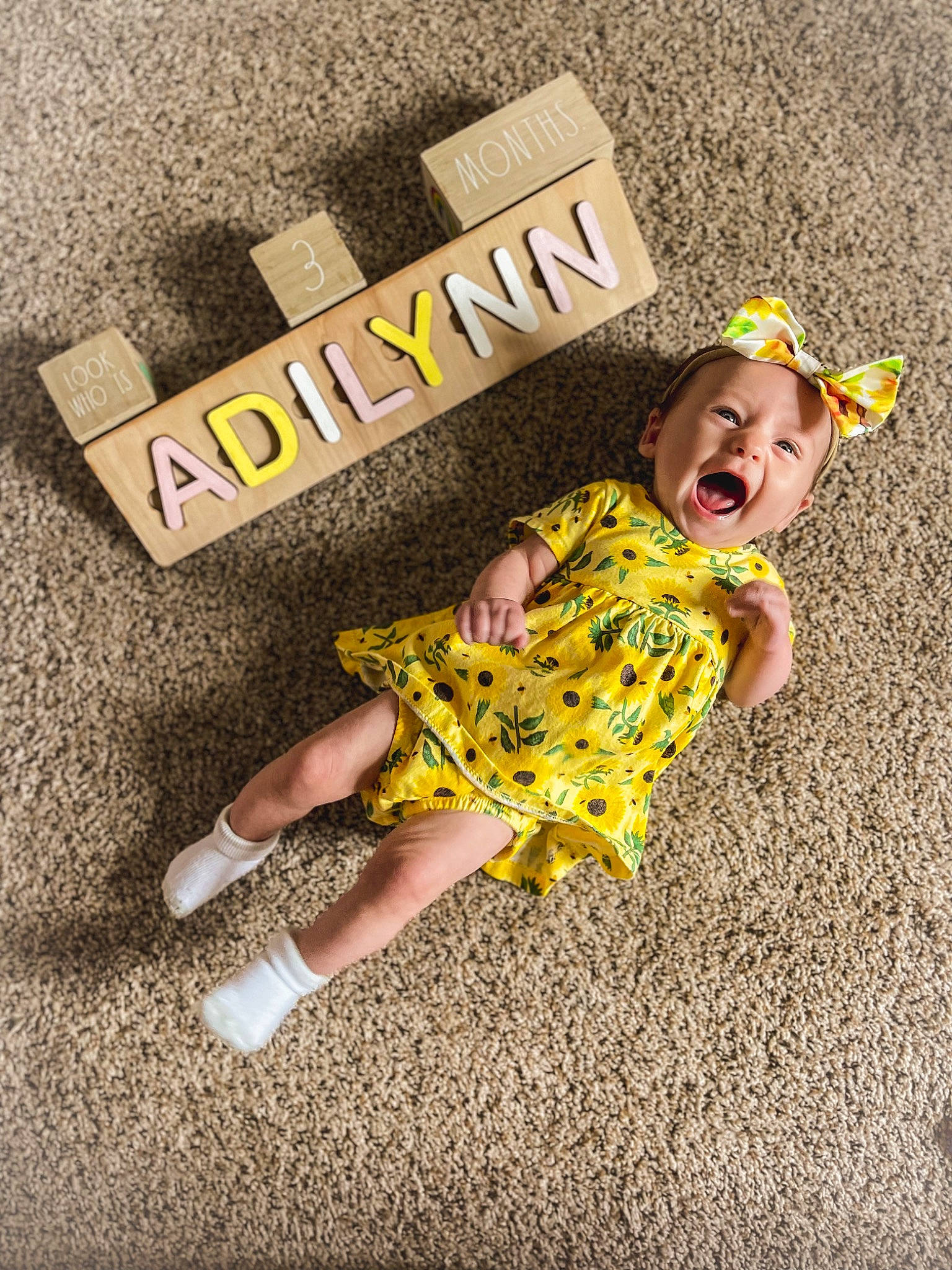 Adilynn is registered to the contest to win money with this photo: baby_toddler_clothing, child, child_model, flooring, font, fun, grass, happy, hat, illustration, logo, pattern, people_in_nature, person, play, recreation, sandal, sleeve, sun_hat, t_shirt